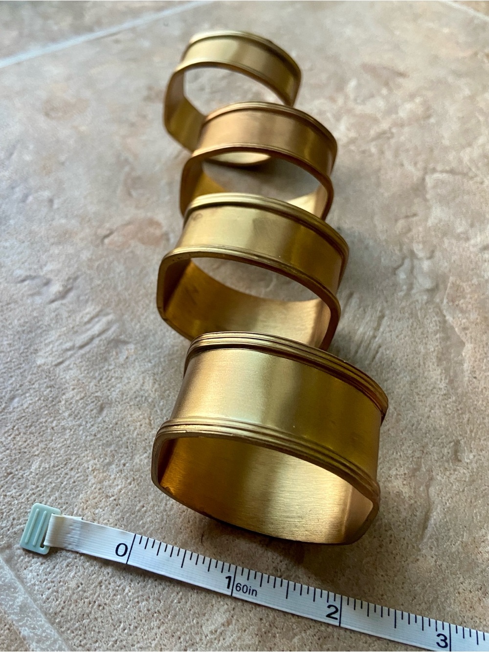 Set a four brass napkin rings